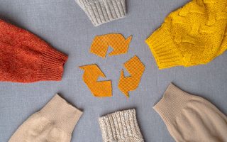 Clothing,Recycling.,Used,Clothes.,Ecological,And,Sustainable,Fashion.,Sleeves,Of Clothing recycling. Used clothes. Ecological and sustainable fashion. sleeves of autumn woolen sweaters. reduce waste concept. High quality photo